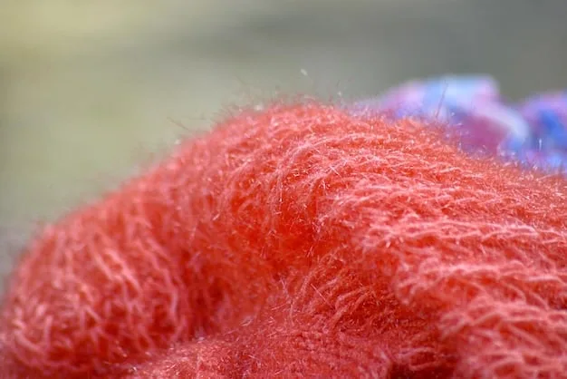A close-up shot of various fabric textures, including merino wool, cotton, fleece, and nylon, showcasing the differences in breathability and weather-resistance.