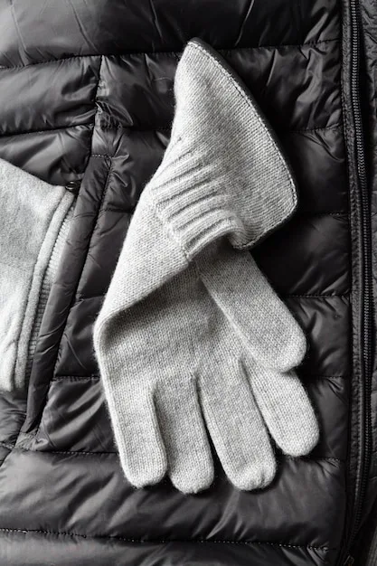 Three different mid-layer options: a fleece jacket, a down vest, and a synthetic insulated jacket, each showcasing their unique texture and insulation properties.