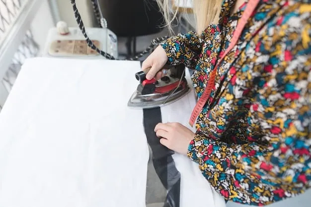 A close-up of a woman carefully ironing a silk blouse on a padded ironing board. She is using a low-heat setting and a pressing cloth to protect the fabric. The scene is well-lit, highlighting the smoothness of the ironed silk.