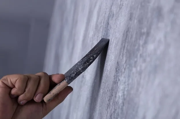 A close-up shot of a homeowner using a drywall knife to apply joint compound to a small hole in a drywall wall. The image should clearly show the tools and materials used, as well as the technique for applying the compound smoothly.