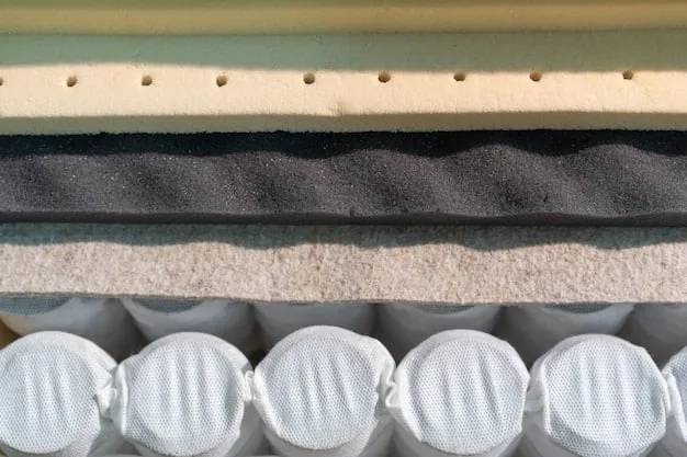 A detailed close-up of different mattress layers showing the construction and materials used, such as memory foam, coils, and latex.