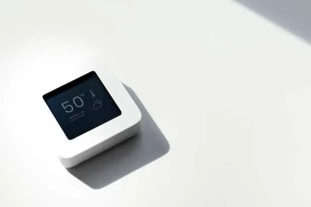 A close-up of a sleek, modern smart thermostat on a wall in a contemporary home, showing a digital display with temperature and energy usage statistics, symbolizing efficiency and control.