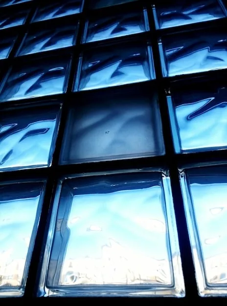 A close-up shot of a triple-pane window cross-section, clearly showing the three layers of glass and the gas-filled spaces in between, highlighting the advanced insulation technology.