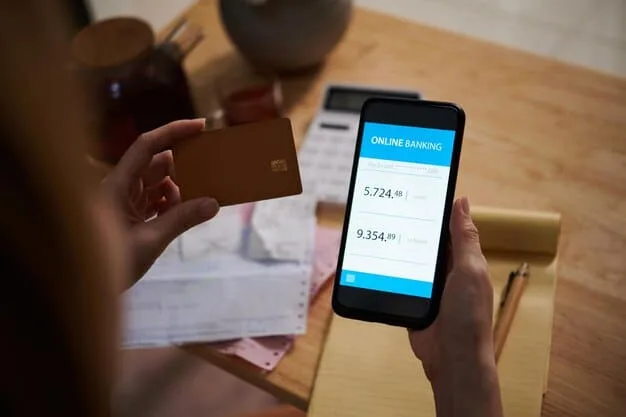 A close-up shot of a smartphone screen displaying the SHEIN app's checkout page with a discount code field highlighted, a debit card in hand ready for payment.